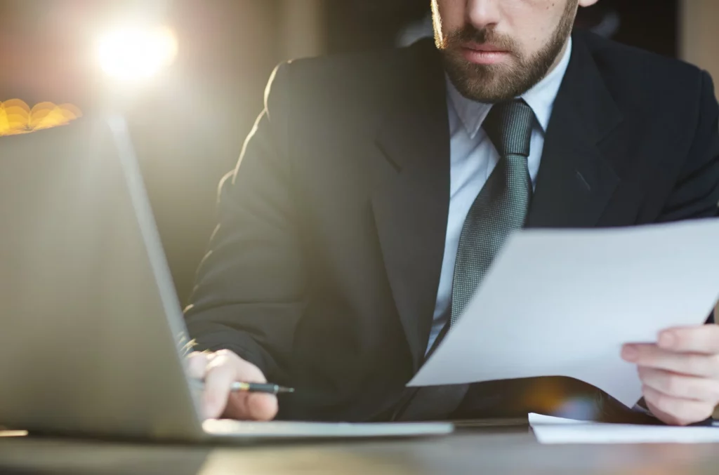 bearded businessman working with documents in office