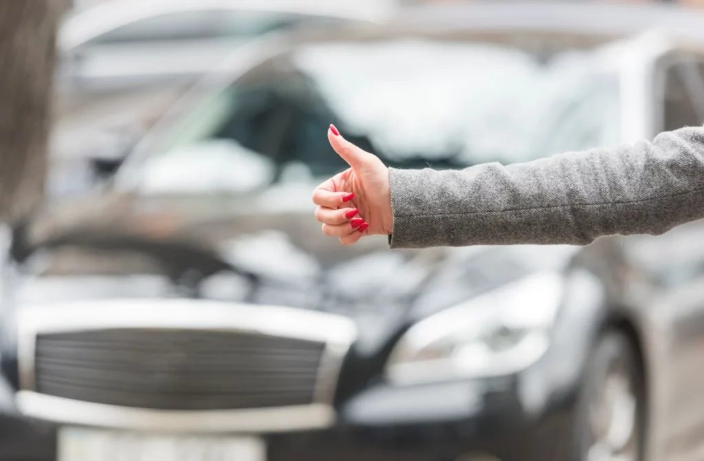 brunette businesswoman hitchhiking